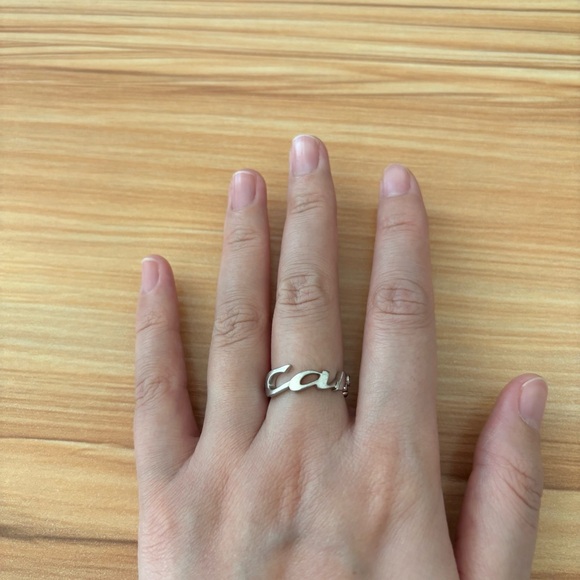 Cartier 18k white gold signature ring with 3 diamonds.